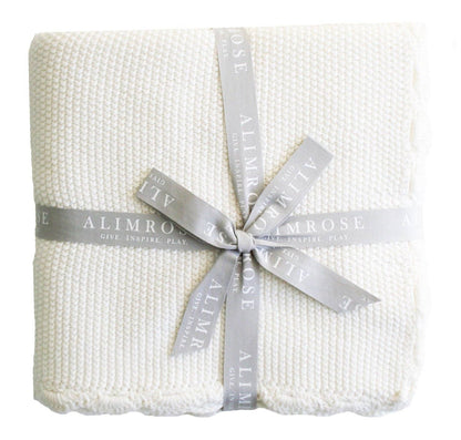 Ivory moss stitch baby blanket folded neatly on a white background.