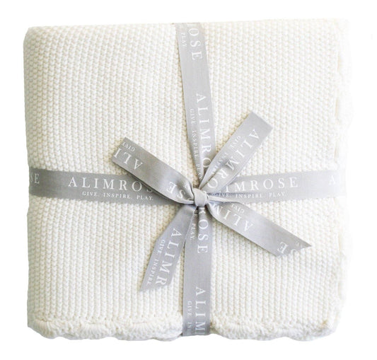 Ivory moss stitch baby blanket folded neatly on a white background.