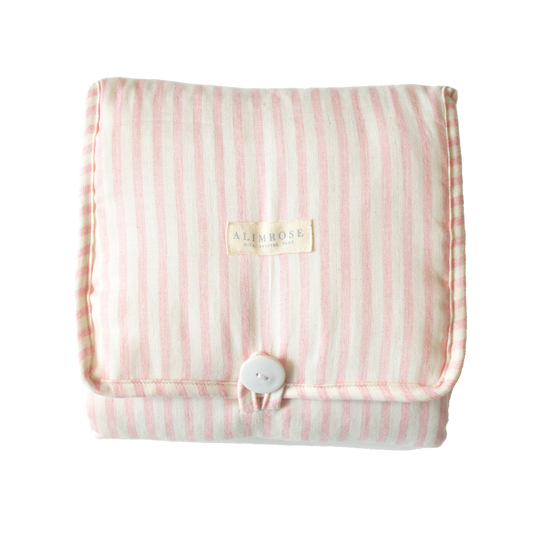Foldable pink striped quilted change mat displayed flat on a white background.